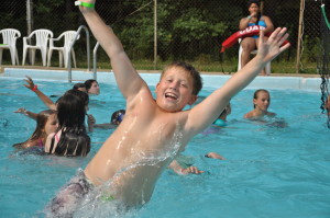 Boy splashing in pool